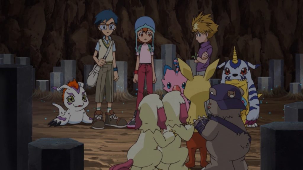 Cena de Digimon Adventure: O Lobo Ereto no Deserto: Digiescolhidos e seus digimons dentro das ruínas.