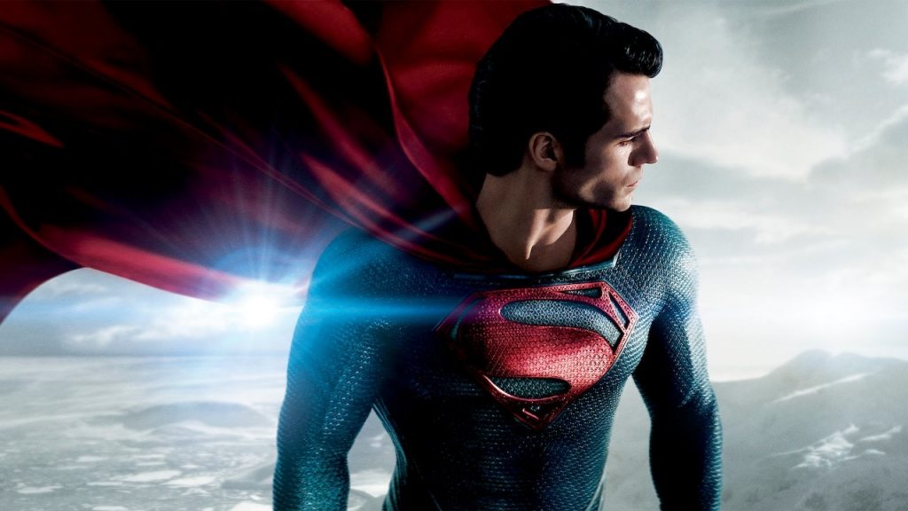 Superman Voando com seu uniforme clássico olhando para baixo. Poster oficial de "O Homem de Aço"