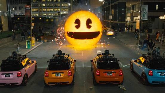 monstro em formato de emoji sorrindo e diante dele quatro carros coloridos