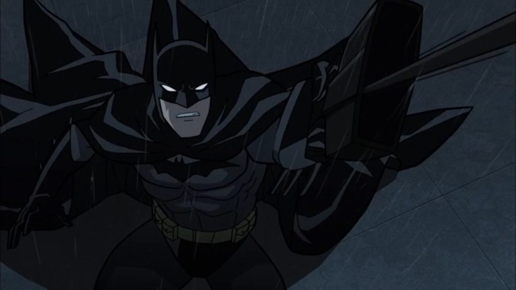 Batman lança seu bat gancho em uma cena em plongée.