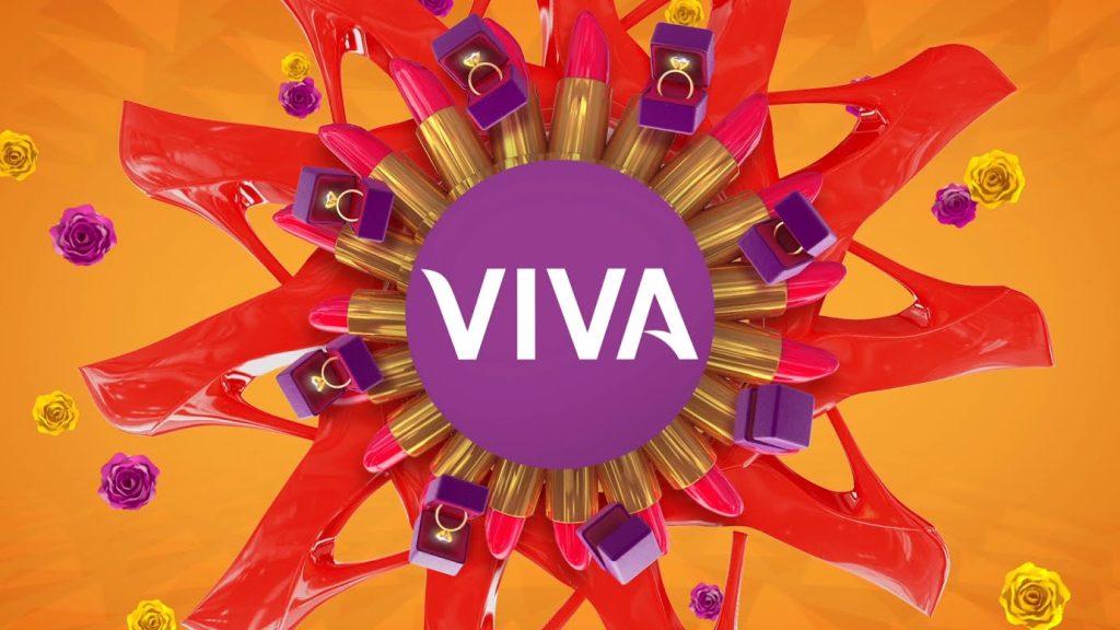 Logo do canal VIVA, com nome do canal em branco , dentro de uma bola roxa e com batons e sapato vermelho ao redor