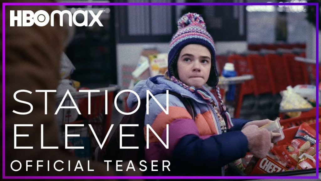 Imagem promocional da série "Station Eleven". Nela, vemos uma criança, agasalhada, com cara de desconfiada, em frente a um carrinho de supermercado. Em volta, estão os dizeres: HBO MAX - STATION ELEVEN - OFFICIAL TEASER